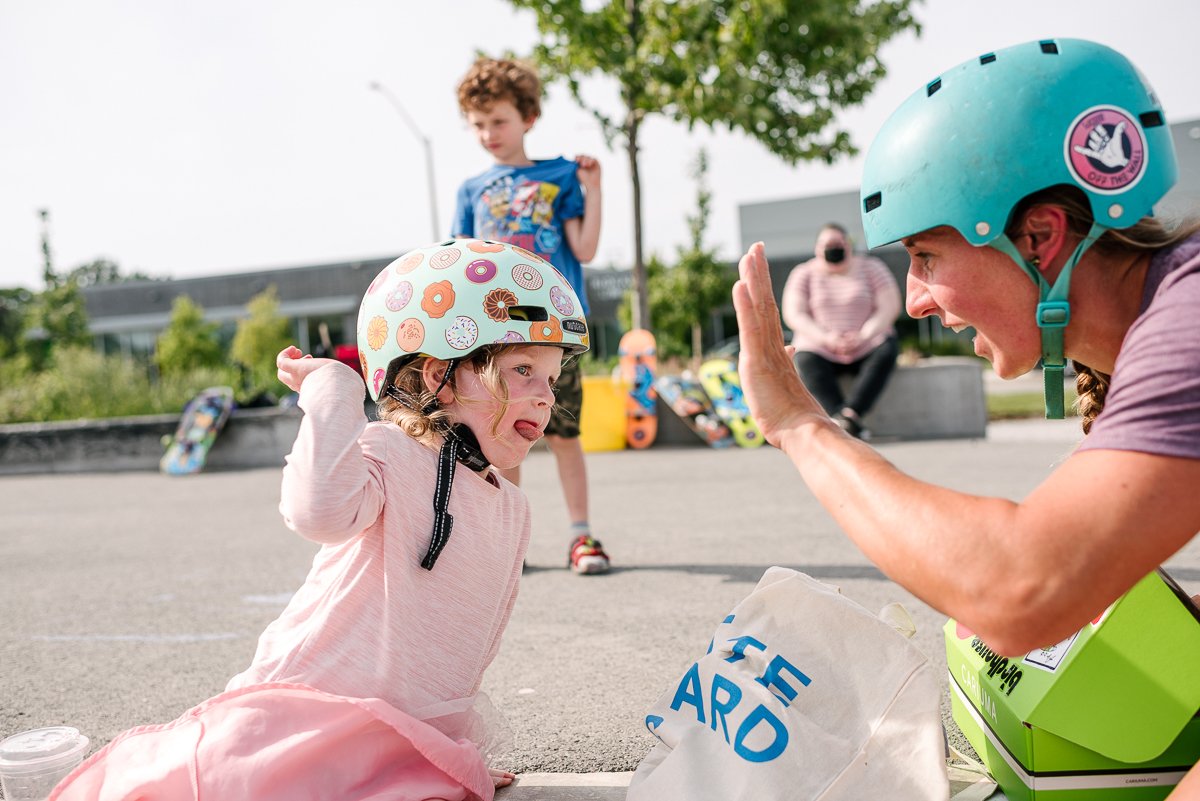 Happy girl child wearing helmet giving clap