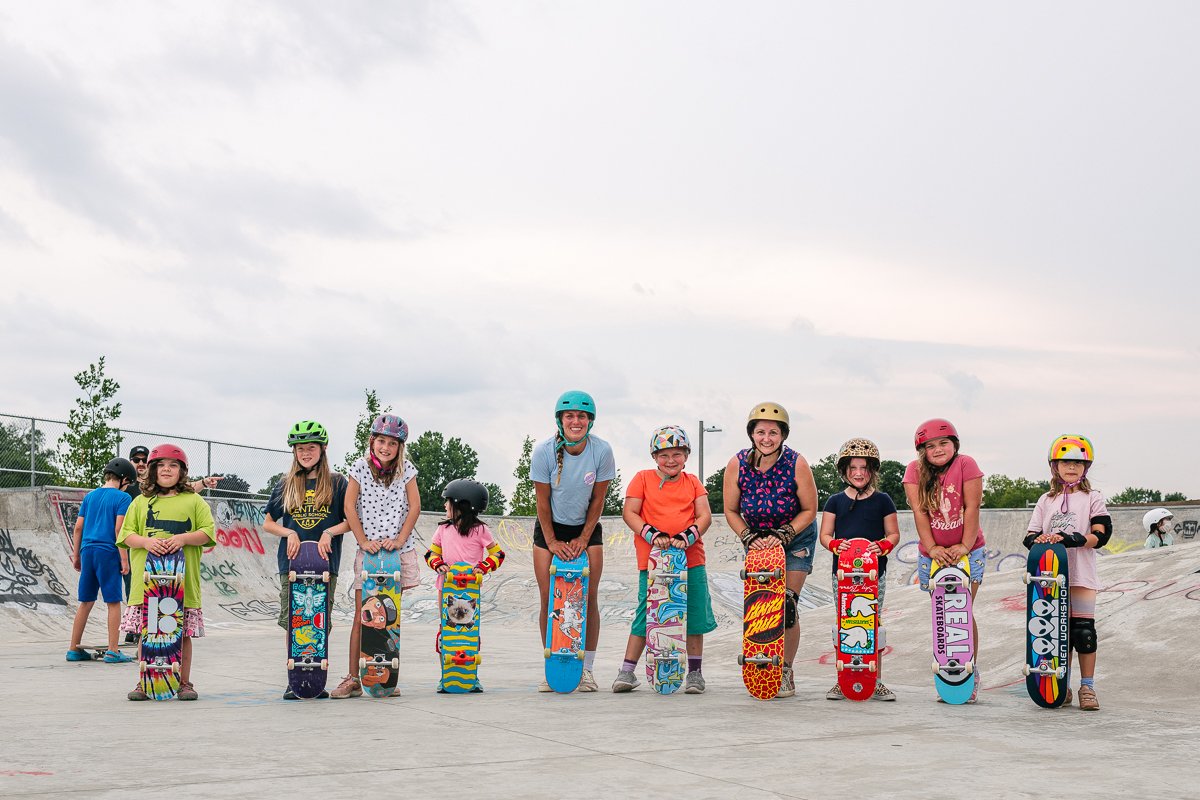 Group of girls posing with the skateboards
