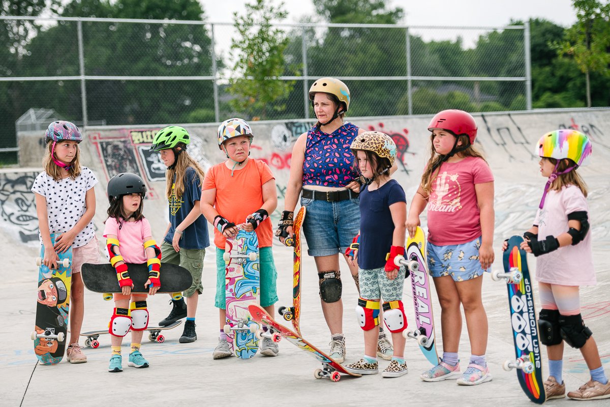 Girls taking learning sessions of skateboarding.