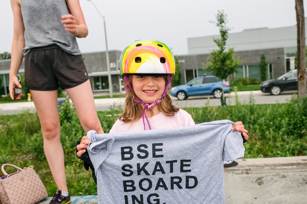 Girl holding tshirt with skateboard quote at the learning camp