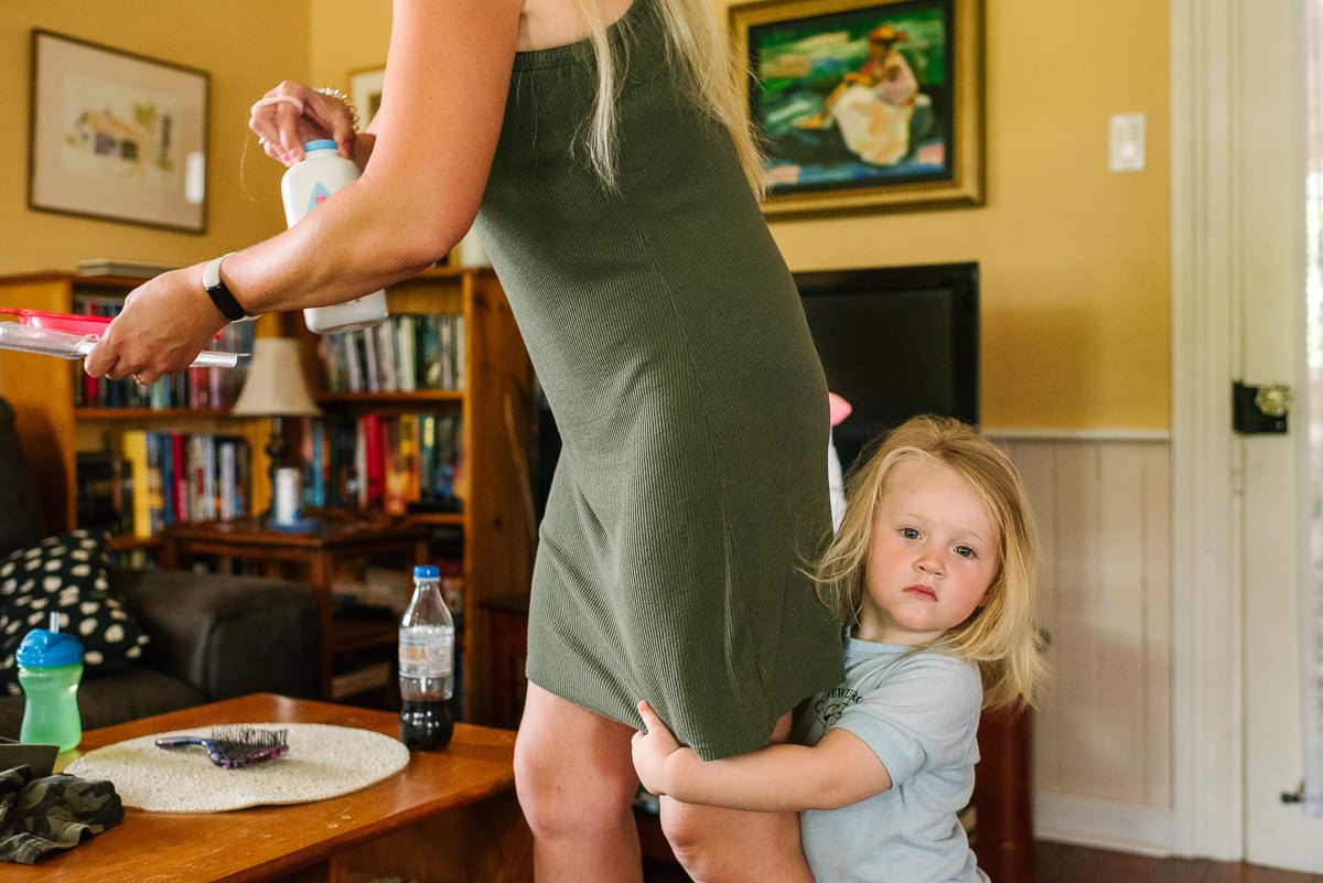 Cute little kid clinging to his mom's leg