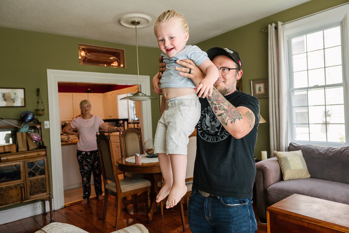 Happy kid in the arms of his father enjoying jumping