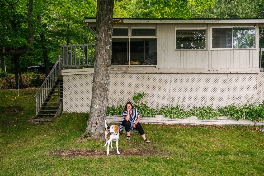 Dog and his guardian are sitting in the backyard