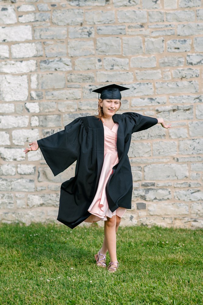 Happy school girl posing on her graduation day