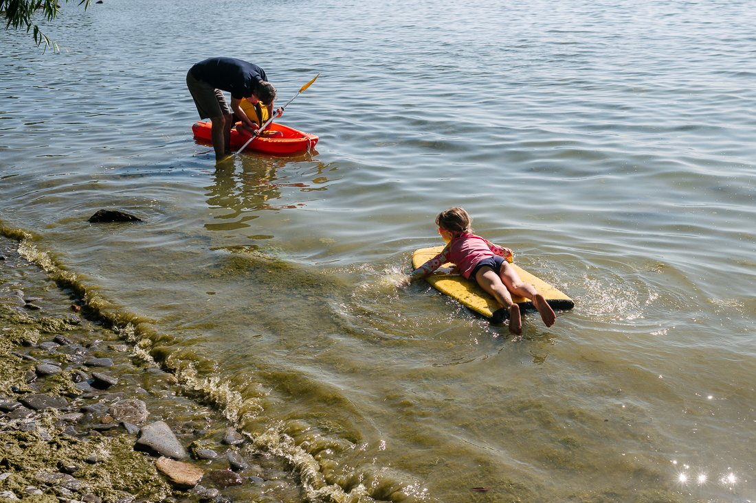 Kids splaying in water at the beach. 