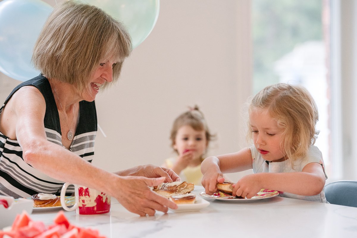 Woman and her grand daughter eating sweets while celebration.