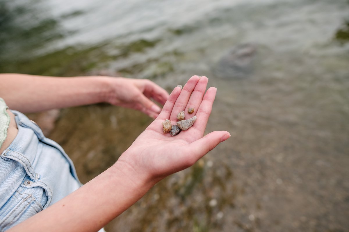 Girl holding pebbles in her hands.