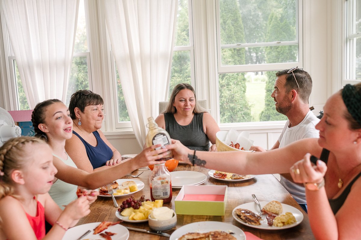 Family having fun while their lunch in the dining area.