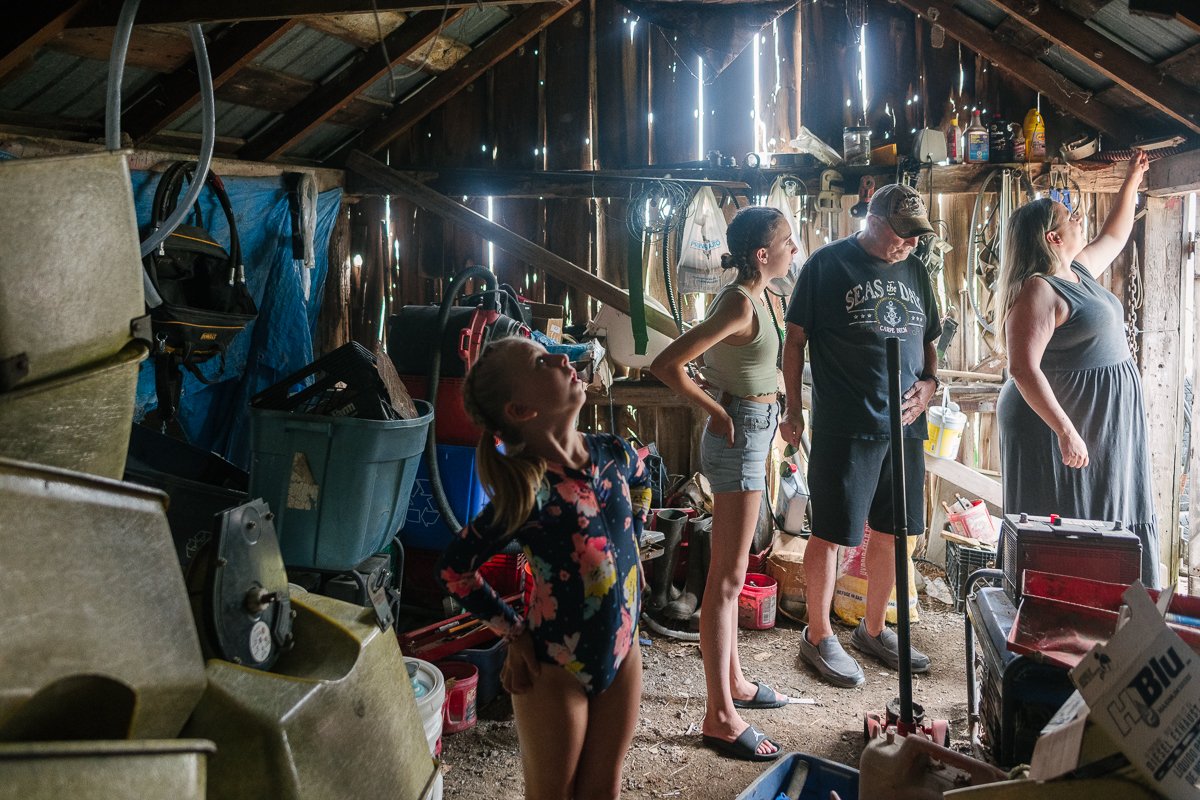 Parents and kids in the cottage looking at all things lying.