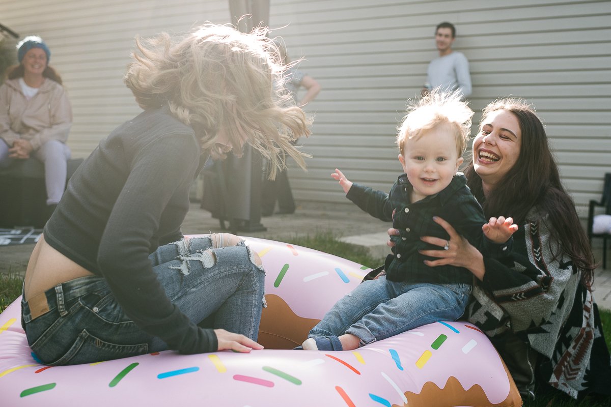 Little boy playing with his family.