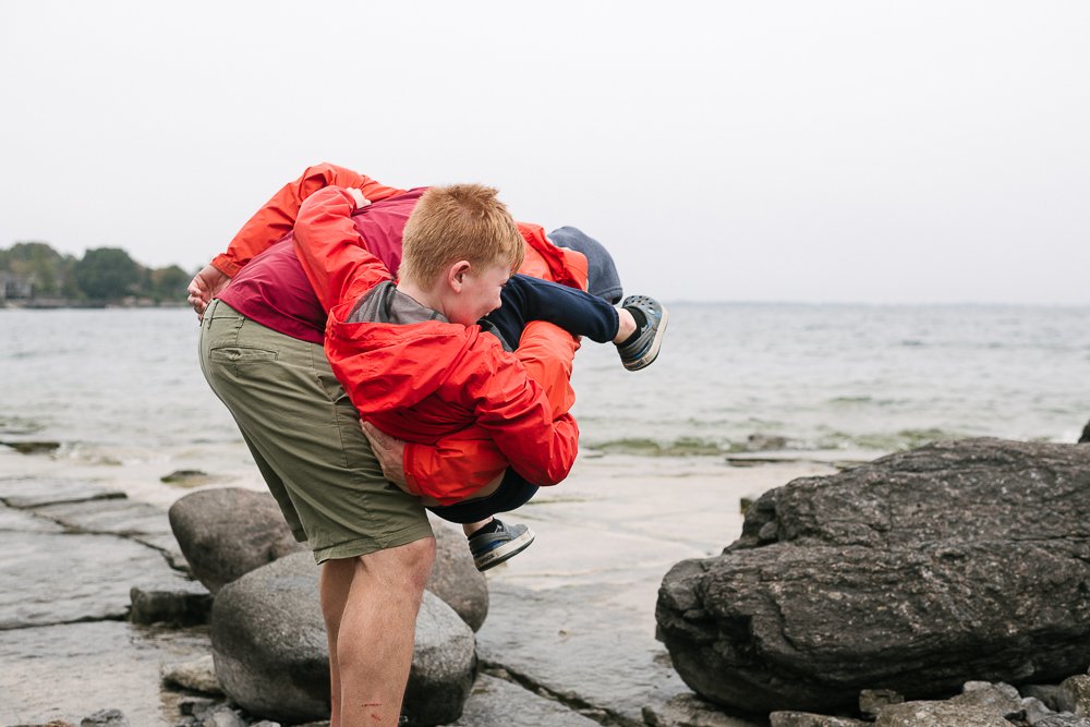 Father and son playing near the lake