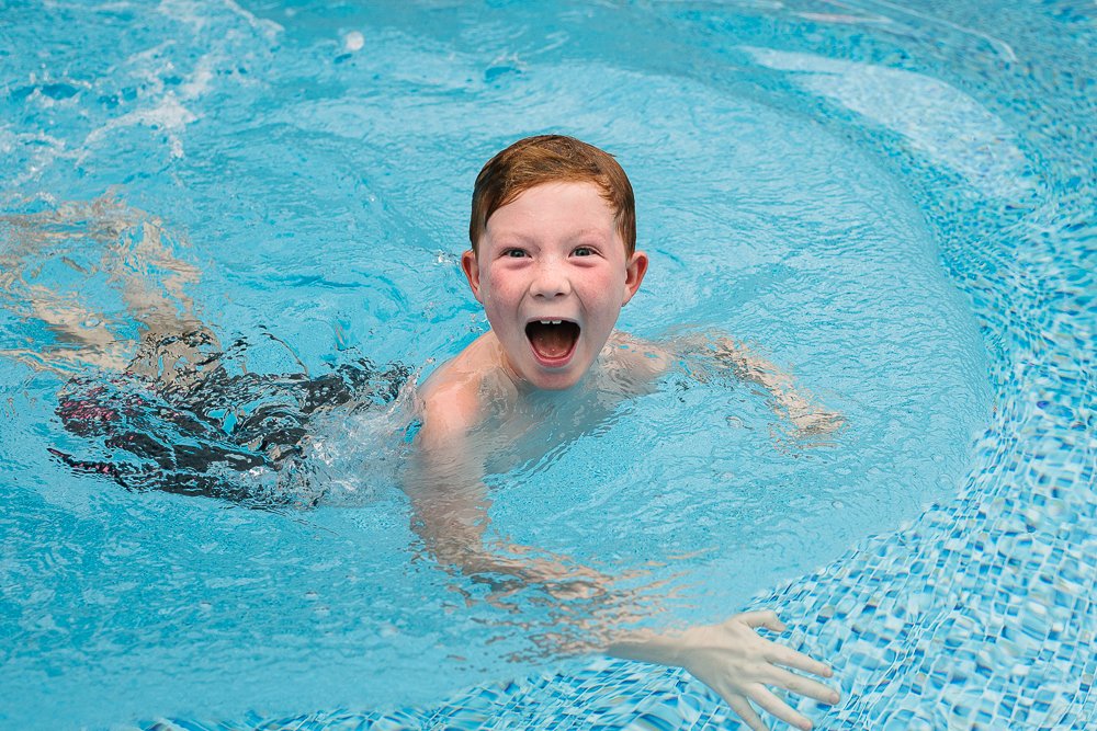 Little boy swimming in the pool with so much happiness