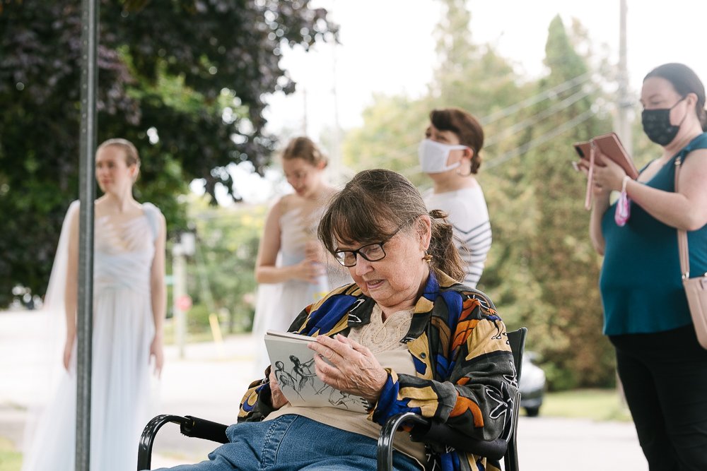 Artist painting the ballerinas sitting on the chair