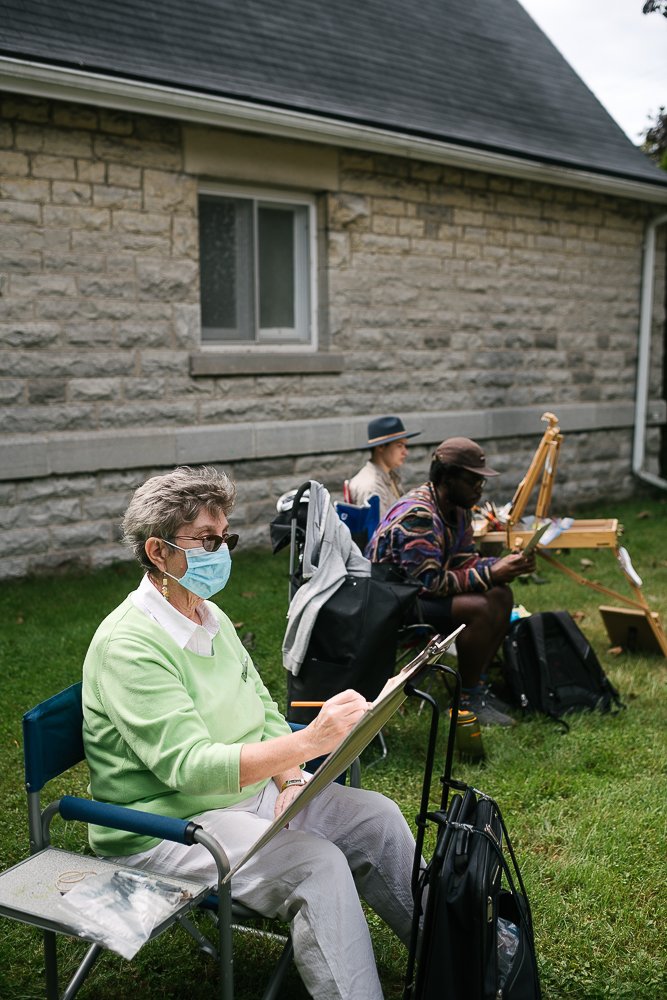 Artists painting the ballerinas on the outdoor painting event