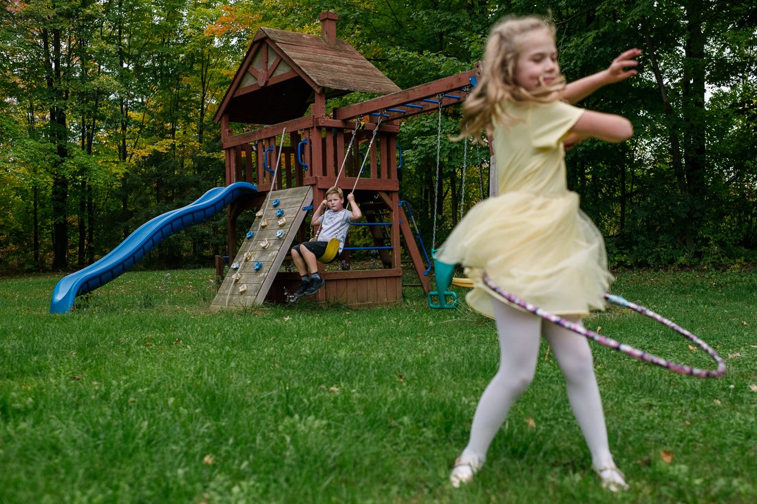 Girl playing with hoola hoop in the garden