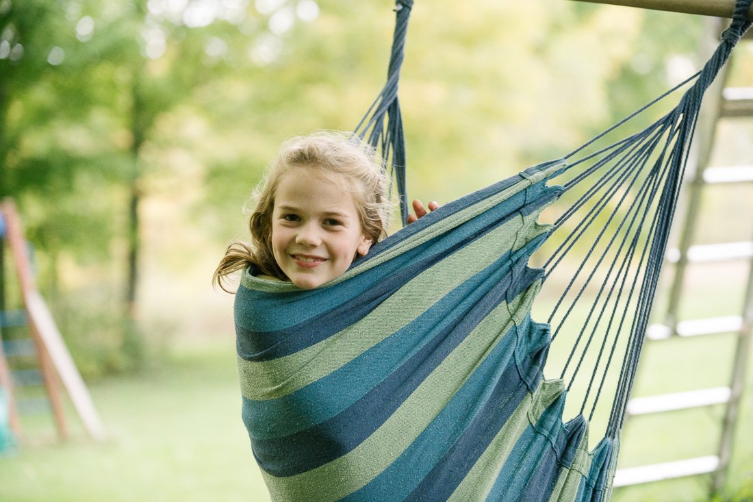 Girl sitting on the hammock on the picnic.