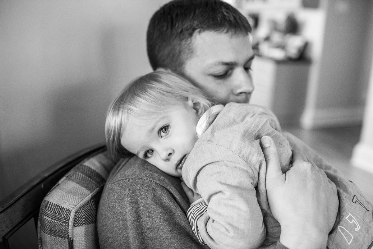 Black and white image of father and daughter hugging each other