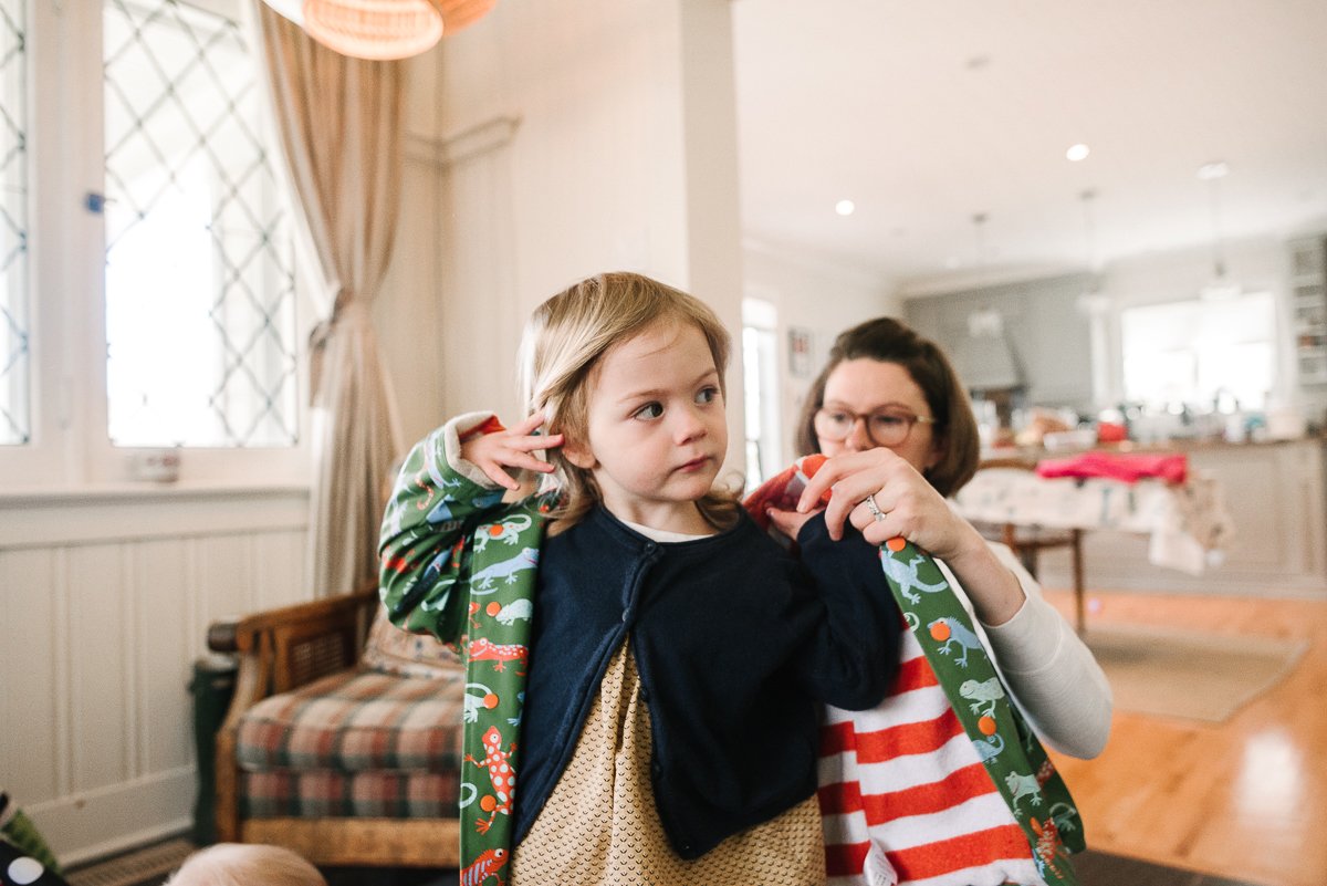 Mother getting her daughter ready for the photoshoot wearing her the blazer