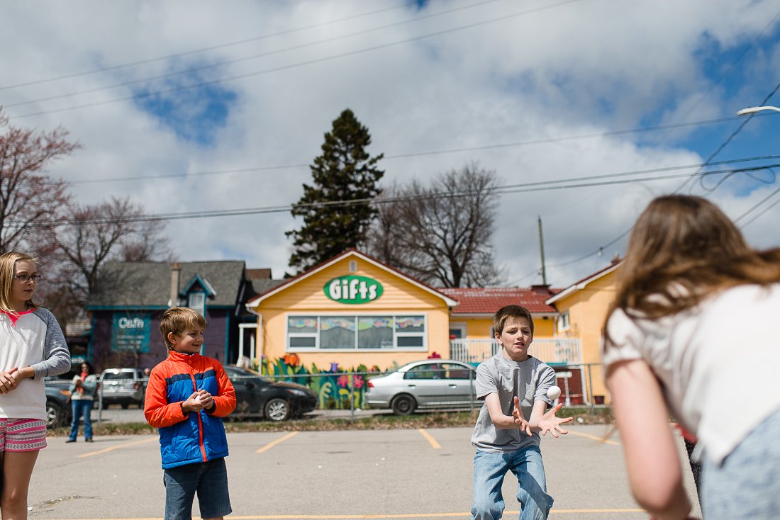 Boy catching egg playing egg toss game with his family on picnic.