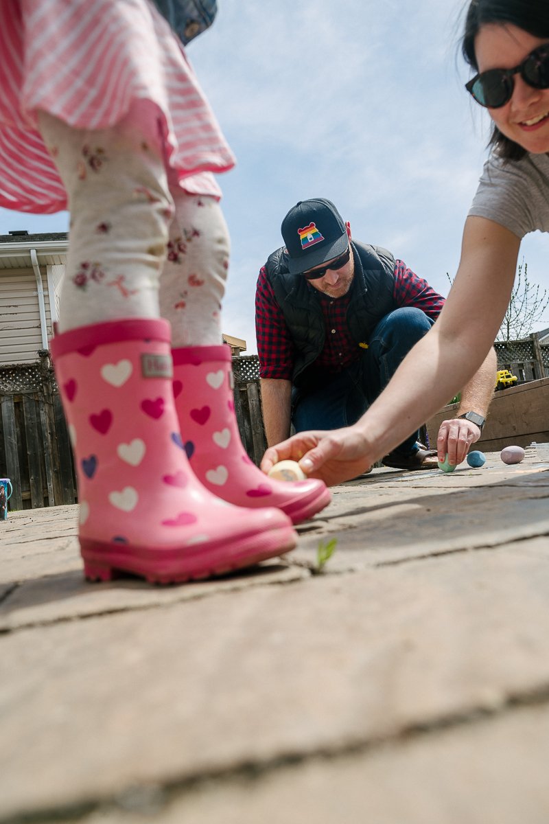 Girl playing with her parents in the ground