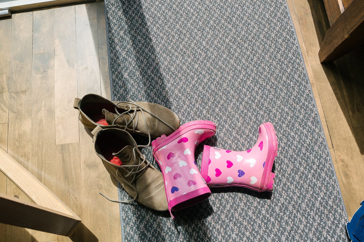 Pair of shoes of little girl lying on the floor