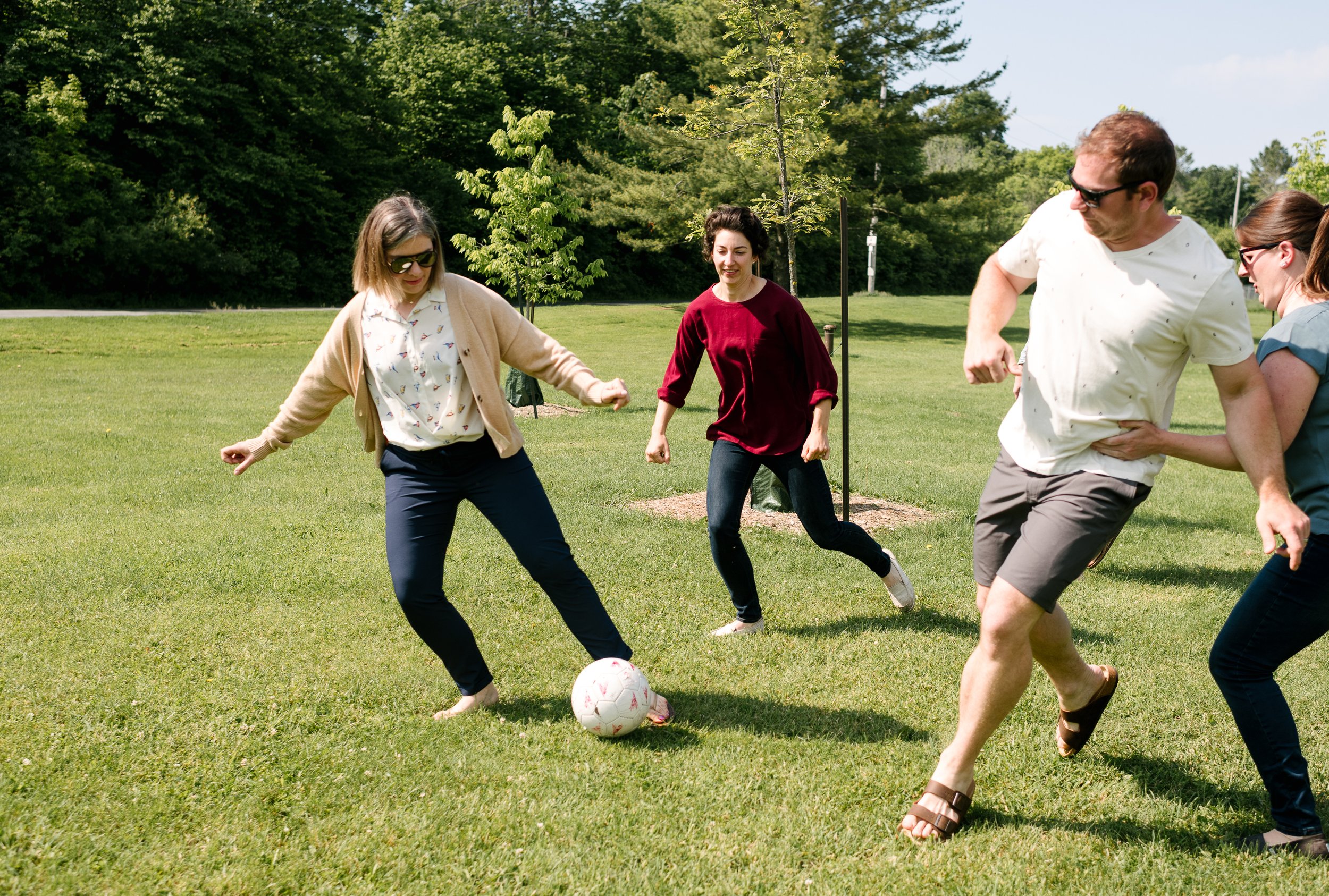 Family playing football together in the ground