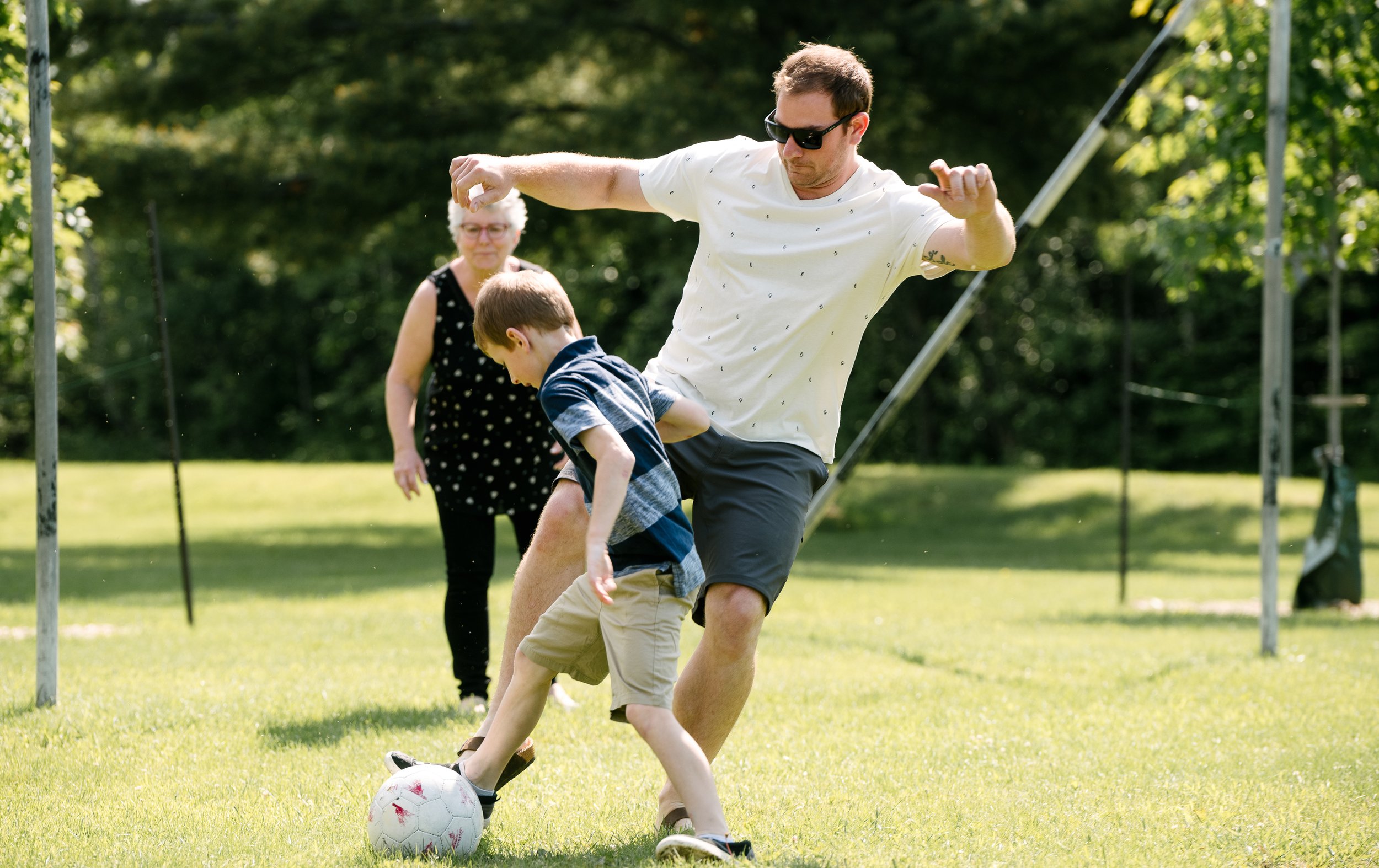 Dad and son playing football match.