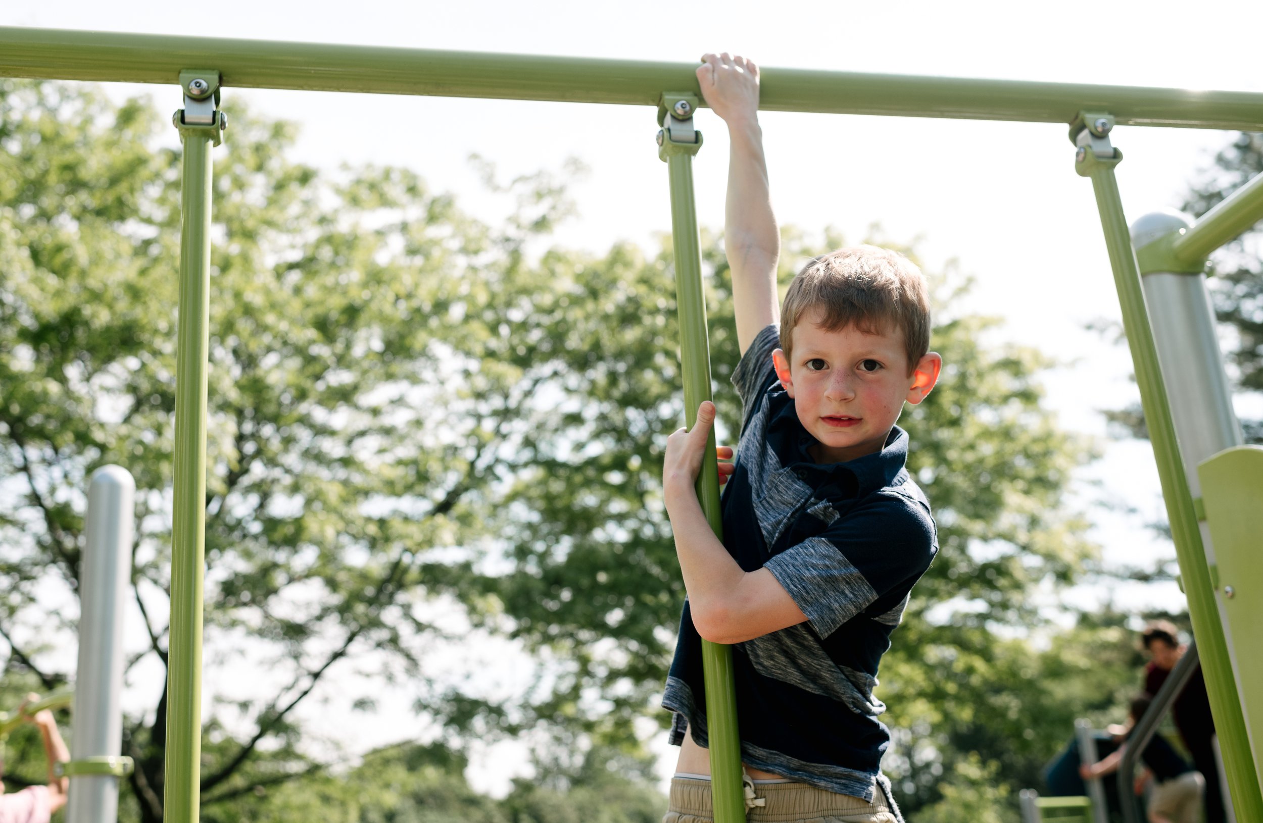 Boy hanging in the playground