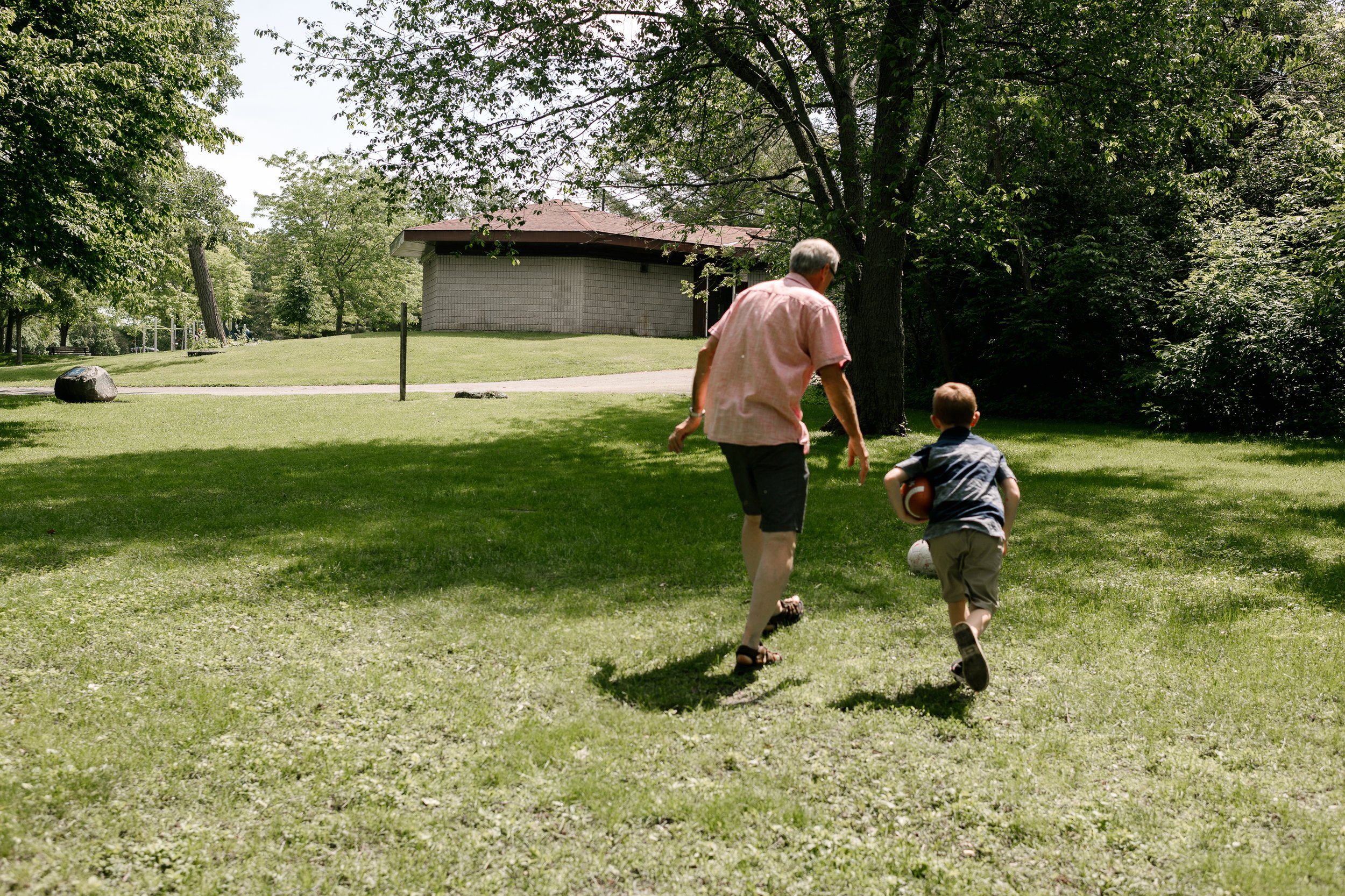 Grandfather running with son in the park