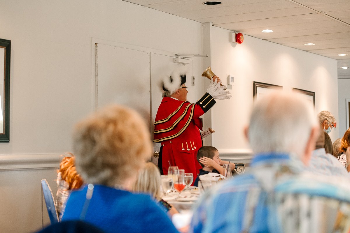 Town crier making announcement in the party. 