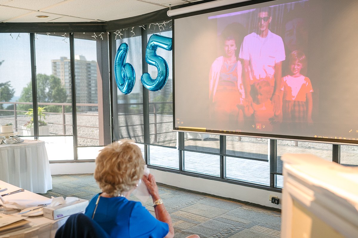 Couple watching old pictures on the screen. 