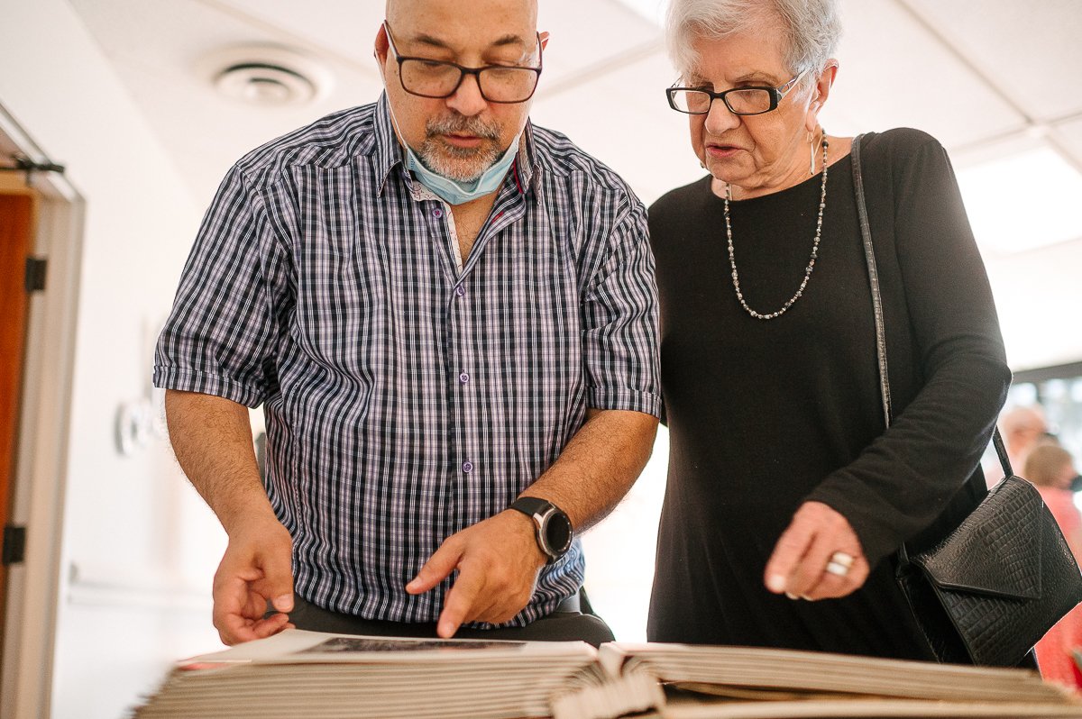 Couple watching old black and white pictures in the album. 