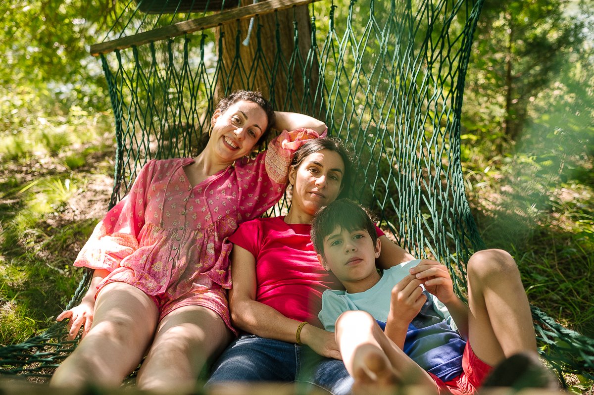 Children playing with mom sitting in the garden