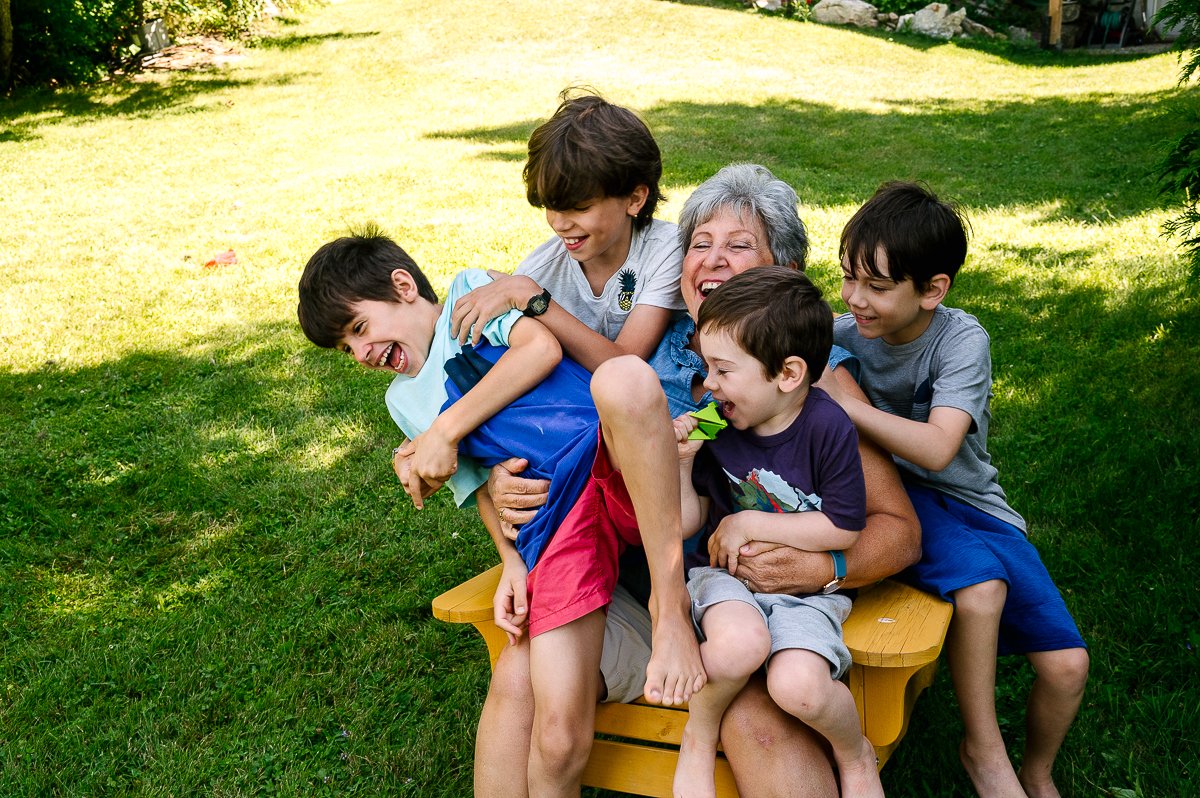 Children playing with their grandmother in the garden