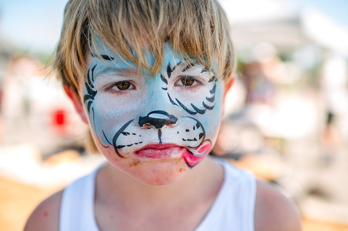 A boy with face painting in the skating event.