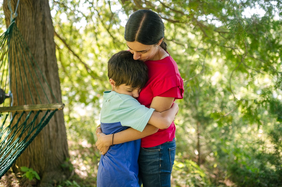 Mom hugging her son tight