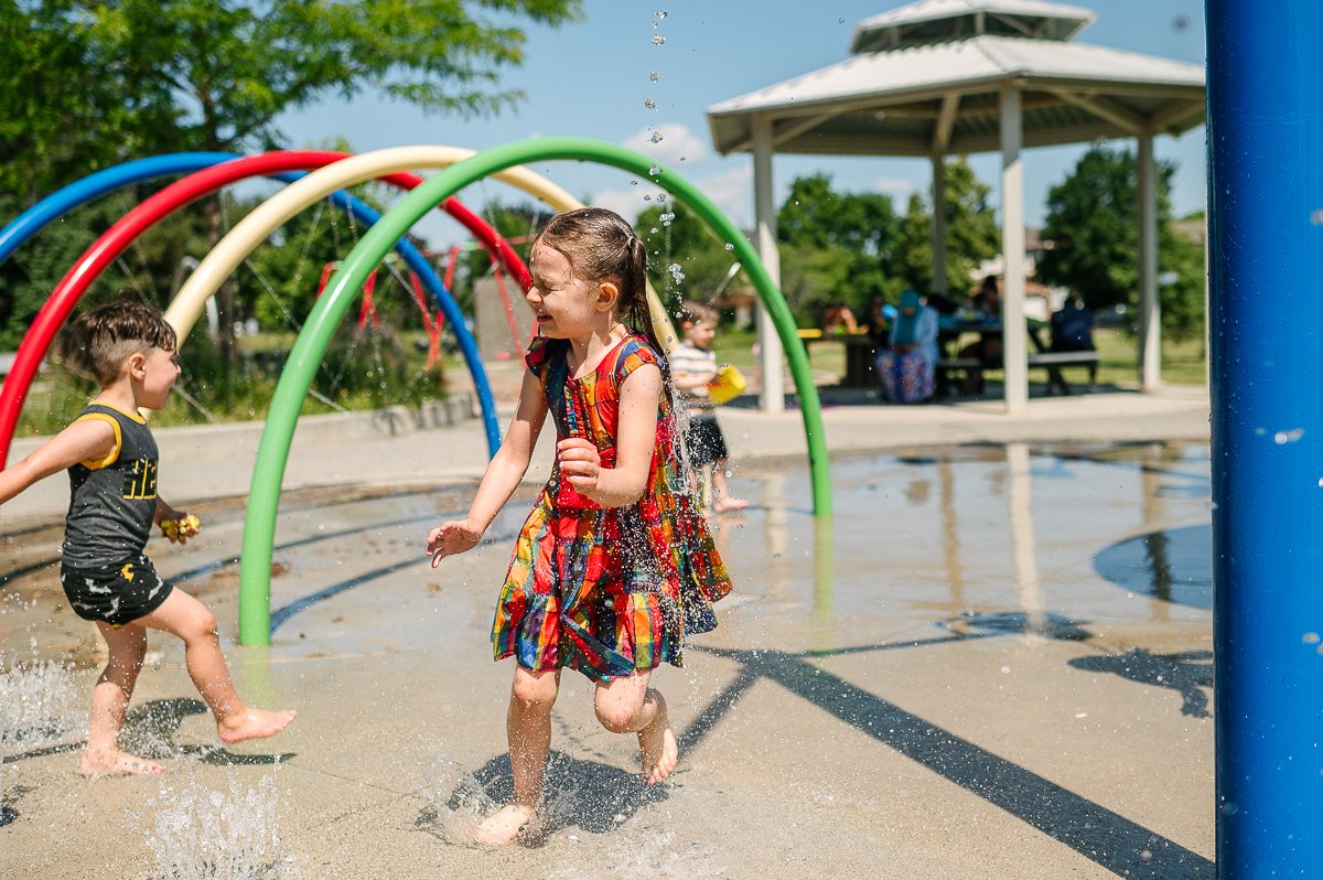 Boy and girl playing in the water park.