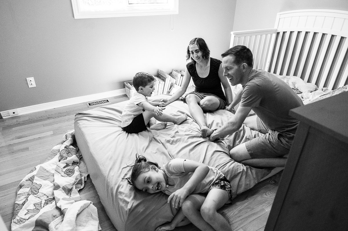 Black and white image of mom, dad and kids. 