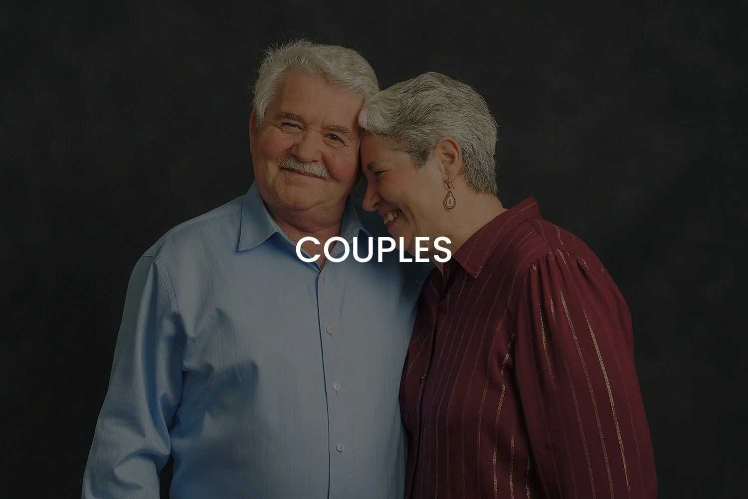 An elderly couple smiling and leaning their foreheads together, with the word 'COUPLES' overlayed in the center.