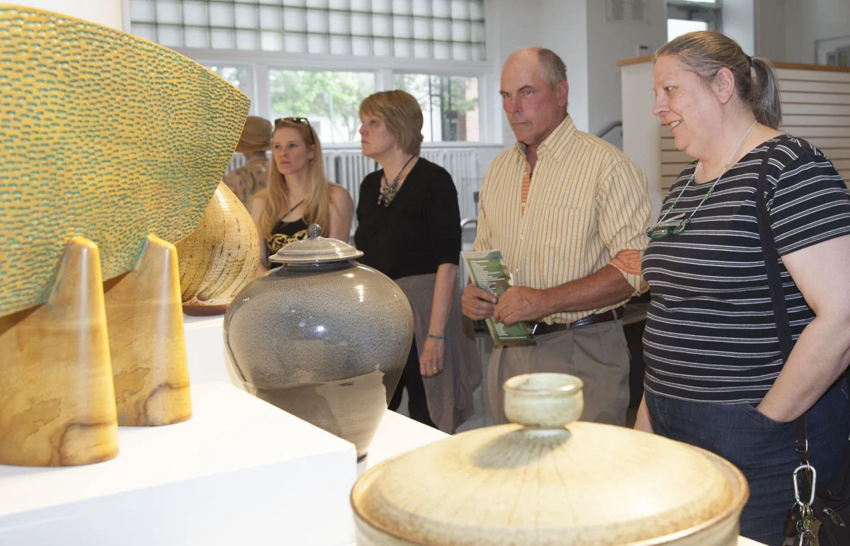 Guests enjoy the ceramic/sculpture display, including Ken Thompson's Form with Wedges, purchased in 2002, Fly Shaffer's Casserole, purchased in 1958, and Rex Fogt's "A Winter's Jar".