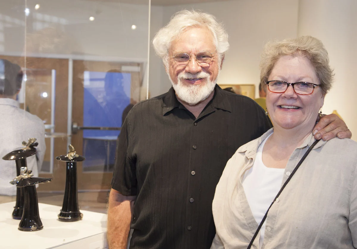 Jack Schmidt and his wife Shawn Messenger pose with Jack's glass sculpture that won an award from Toledo Area Artists Exhibit in 1971.