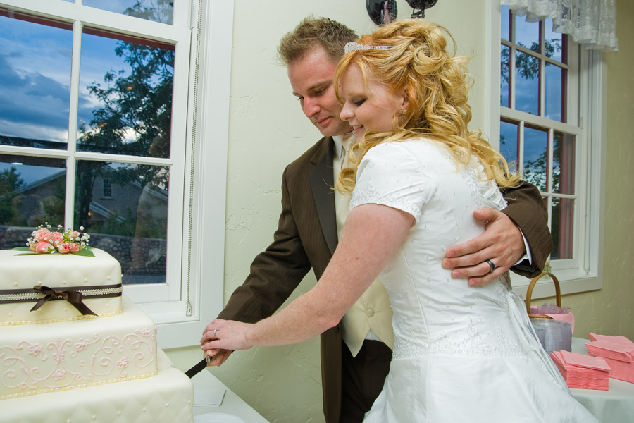 bride-and-groom-cutting-wedding-cake-smoot-hall.jpg