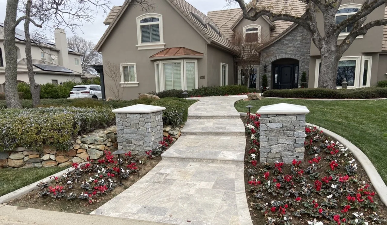 Stone Masonry exterior veneer, col;umns, and travertine paving