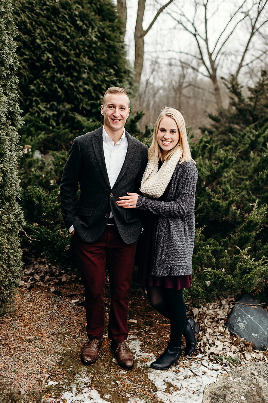 Engaged couple smiling at the camera