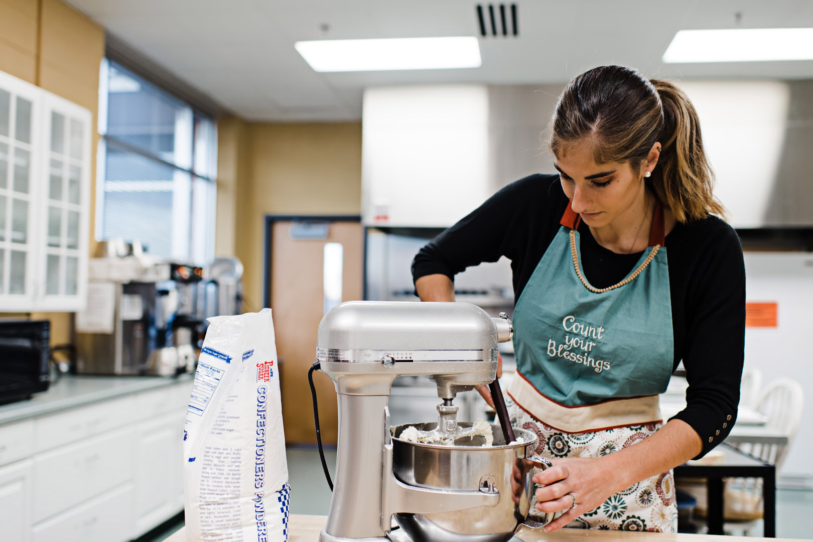 Diana scraping bowl of icing