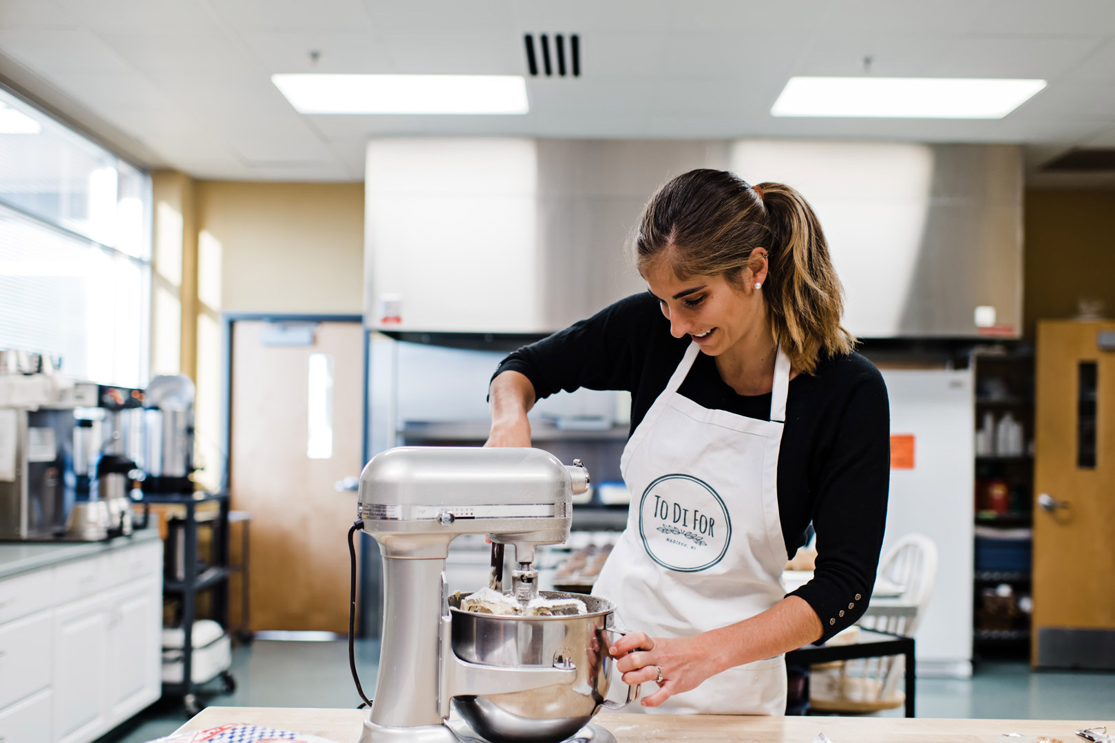 Diana scraping icing out of the mixing bowl