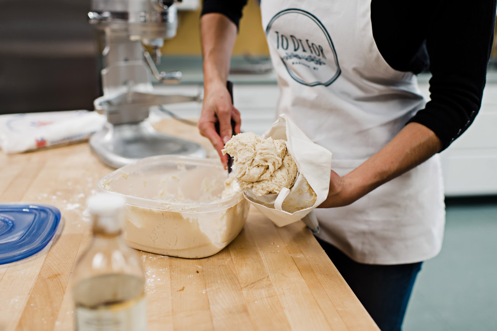 Scooping icing into a piping bag