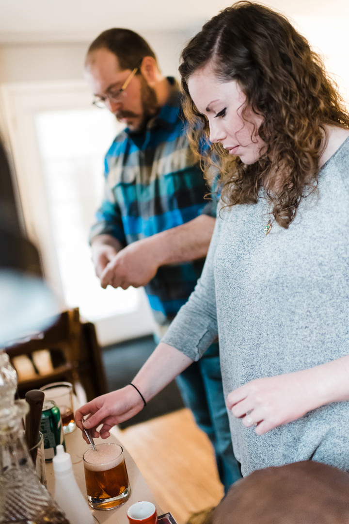 Engaged couple making brandy old fashioned together