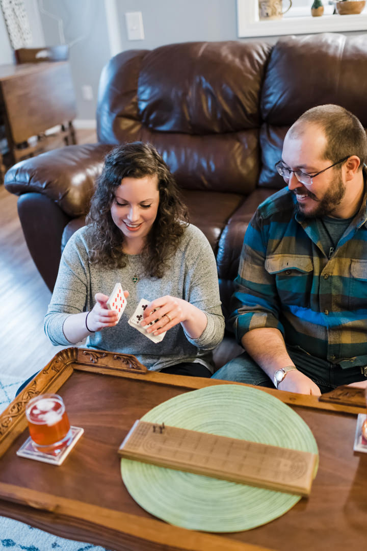 Engaged couple playing cribbage