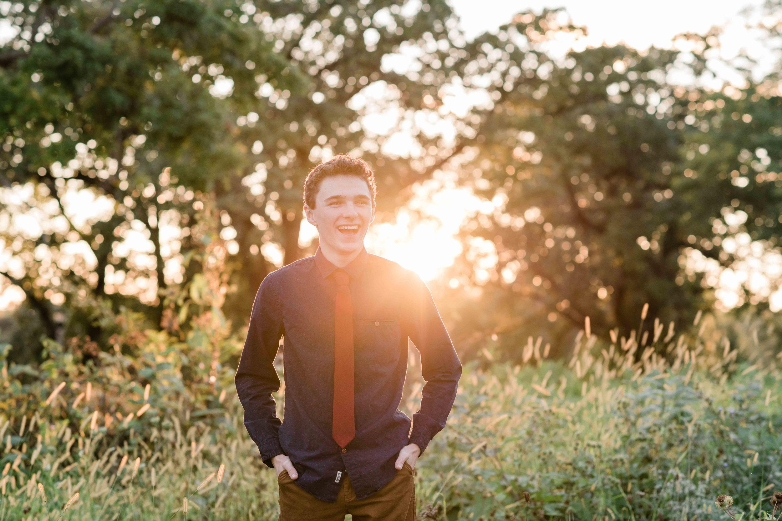 High school senior backlit by the sun